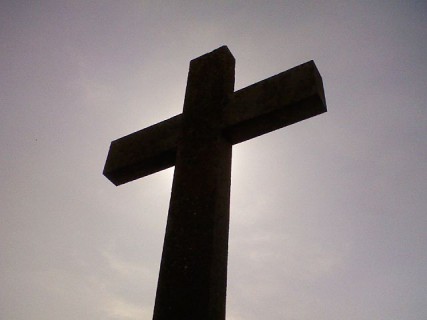 Close up, silhouetting the cross at Llanddwyn Isle (Angelsey, Wales). 