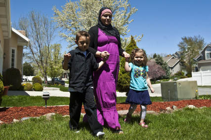 Sharifa Al-Qaaydeh and her kids Sajed, 5, and Summer, 3, walk around their home Wednesday May 4, 2011 
