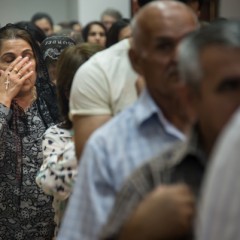 A Chaldean Catholic woman holds a rosary during a mass at Saint Joseph's Chaldean Catholic Church in the Ankawa neighborhood of Erbil, Iraqi Kurdistan, June 27, 2014. Many Iraqi Christians have fled to Erbil from other parts of the country because of violence from Muslim extremists.