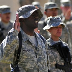 Tech. Sgt. LaMarcus Molden, 9th Air and Space Expeditionary Task Force-Iraq personnel manager, recites the oath of enlistment along with 125 other service members during a re-enlistment ceremony at Al Asad Air Base, Iraq, Oct. 5, 2011. Molden is deployed from Ramstein Air Base, Germany, and is from Albany, Ga.