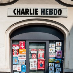 A Charlie Hebdo building with cartoons on the doors. Photo courtesy of Brigitte Djajasasmita via Flickr