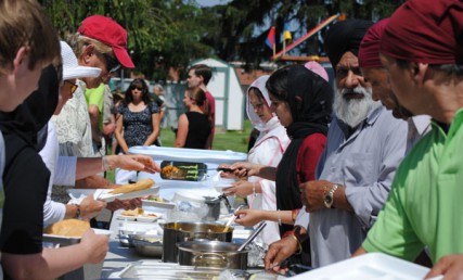 Members of the Sikh temple feed guests from Arms of Compassion 