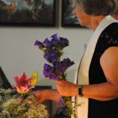 Rev. Toni Niemiec of the Center For Spiritual Living lights a candle at an Interfaith Pride Service/Tracy Simmons - SpokaneFAVS